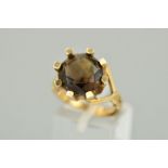 A 9CT GOLD SMOKY QUARTZ RING, the circular smoky quartz within a thick eight claw setting with a