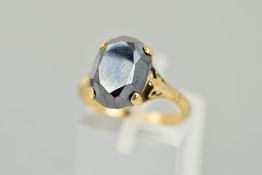 A HEMATITE RING, the faceted oval hematite within a flour claw setting, stamped 9ct, size L 1/2,