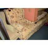 A FLORAL UPHOLSTERED TWO PIECE LOUNGE SUITE comprising of a two seater settee and an armchair