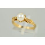 A 9CT GOLD PEARL RING, the single pearl with a white/cream lustre, double leaf detail to the