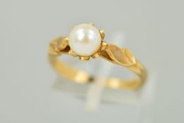 A 9CT GOLD PEARL RING, the single pearl with a white/cream lustre, double leaf detail to the