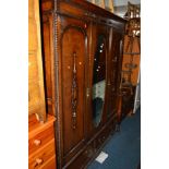 AN OAK TWO PIECE BEDROOM SUITE comprising of a single mirror door wardrobe above two drawers,