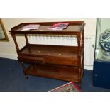 AN EDWARDIAN MAHOGANY THREE TIER BUFFET, the top shelf with a gallery above two drawers joined by