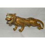 A BRASS ORIENTAL STYLE TIGER, approximate length 35cm