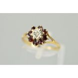 A 9CT GOLD LATE TWENTIETH CENTURY GARNET AND DIAMOND ROUND CLUSTER RING, ring size M 1/2, hallmarked