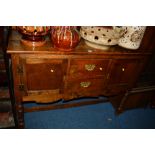 A REPRODUCTION GEORGIAN STYLE OAK SIDEBOARD with two short drawers raised on turned legs united by a