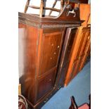 AN EDWARDIAN MAHOGANY DOUBLE DOOR WARDROBE with two short drawers and scrolled cornice, width