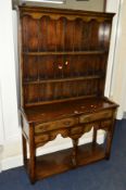 A NARROW TITCHMARSH AND GOODWIN OAK DRESSER the upper section with a two tier plate rack above a