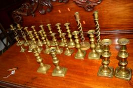 TEN PAIRS OF VICTORIAN AND LATER BRASS CANDLE STANDS together with two other brass candle stands (