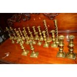 TEN PAIRS OF VICTORIAN AND LATER BRASS CANDLE STANDS together with two other brass candle stands (