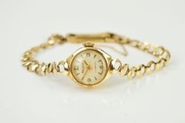 A 9CT GOLD REGENCY WRISTWATCH, the circular white dial with Arabic numeral and baton hour markers to