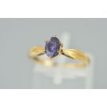 A 9CT GOLD TANZANITE RING, the oval tanzanite within a six claw setting to the tapered shoulders,