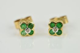 A PAIR OF EMERALD AND DIAMOND EARRINGS, each designed as a central brilliant cut diamond within a