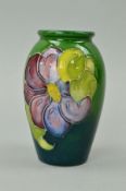 A SMALL MOORCROFT POTTERY VASE, 'Clematis' pattern on green ground, impressed marks to base,