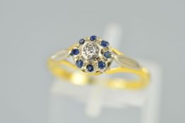 A DIAMOND AND SAPPHIRE CLUSTER RING designed as a central single cut diamond within a circular