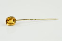 A GOLD AND CITRINE STICK PIN, centring on a cushion cut citrine measuring approximately 13.7mm x