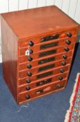 AN EARLY 20TH CENTURY STAINED PINE HABERDASHERY CHEST OF EIGHT DRAWERS, each drawers with various