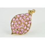 A 9CT GOLD GEM PENDANT of tear drop outline set with oval pink sapphires and brilliant cut diamonds,