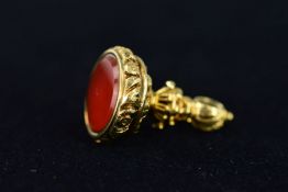 A MID VICTORIAN CARNELAIN SEAL with urn shaped collar and foliate decoration to the grip, set with a