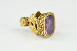 A MID VICTORIAN AMETHYST SEAL, the grip with floral and foliate decoration set with a rectangular