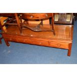 A REPRODUCTION ORIENTAL RECTANGULAR HARDWOOD COFFEE TABLE, with four drawers, width 152cm x depth