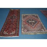 A 20TH CENTURY KUBA CARPET RUNNER, red ground, 280cm x 80cm, together with a Yuruk rug, 160cm x