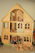 A MODERN THREE STOREY DOLL'S HOUSE, (Early Learning) with furniture and figures (marked with
