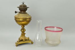 A BRASS OIL LAMP, on trefoil base, with glass funnel and etched shade, approximate height base 42cm