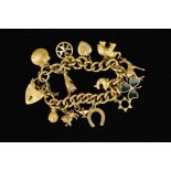 A 9CT GOLD CHARM BRACELET, the curb link bracelet suspending thirteen charms to include a kangaroo