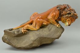 A ROYAL DOULTON EARTHENWARE SCULPTURE, 'Lion on Rock' style two, HN2641, by Charles Noke from the