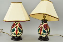A PAIR OF MOORCROFT TABLE LAMPS WITH SHADES, stylized Birds & Trees, approximate height 22cm (not