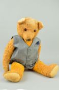 A LARGE WOOL PLUSH TEDDY BEAR, glass eyes, horizontal stitched nose, jointed body, original worn