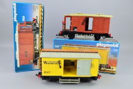 A BOXED PLAYMOBIL G SCALE BOX CAR, No.4111, with a boxed Western Freight Car, No.4122, both appear