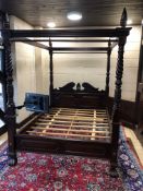 A REPRODUCTION CARVED HARDWOOD FIVE FOOT FOUR POSTER BED, four barley twist uprights and scrolled
