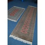 A 20TH CENTURY YOMUT CARPET RUNNER, red and green ground on a geometric design, 314cm x 81cm,