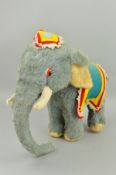 A MERRYTHOUGH INDIAN ELEPHANT, blue mohair with white trim, colourful caparison (missing trim/
