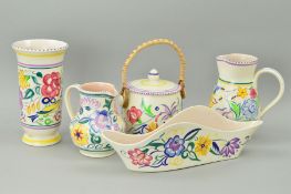 FIVE PIECES OF POOLE POTTERY to include jugs, biscuit barrel, planter and vase, florally decorated