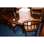 A GEORGIAN MAHOGANY OVAL TOPPED DROP LEAF DINING TABLE and four stick back chairs with drop in