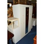 A MODERN THREE PIECE BEDROOM SUITE comprising of three door wardrobe, dressing table with stool