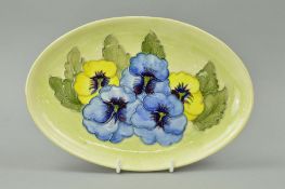 A MOORCROFT POTTERY OVAL TRAY, 'Pansy' pattern on mottled yellow ground, length 23cm