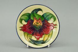 A MOORCROFT POTTERY TRINKET DISH, 'Anna Lily' pattern on cream ground, impressed backstamp and