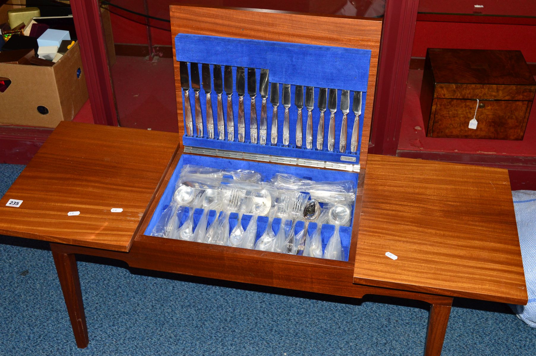 AN ELKINGTON PLATE CANTEEN OF CUTLERY, for eight settings, housed in a low teak table, length