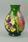 A MOORCROFT POTTERY VASE, 'Hibiscus' pattern on green ground, impressed marks and painted blue