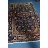 A PERSIAN NAHAVAND RUG, blue ground, 298cm x 170cm (sd)