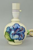 A SMALL MOORCROFT POTTERY TABLE LAMP, 'Hibiscus' pattern on cream ground, impressed and painted blue
