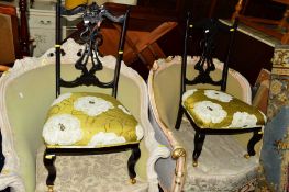 A PAIR OF EDWARDIAN EBONISED NURSING CHAIRS, covered with lime green floral upholstery