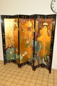 A 20TH CENTURY JAPANESE BYOBU SIX FOLD DOUBLE SIDED SCREEN, gilt and ebonised ground, the panels