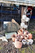 A COLLECTION OF SMALL TERRACOTTA POTS, a white painted metal tiered plant holder, a quantity of cast