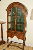 A REPRODUCTION WILLIAM & MARY STYLE GLAZED TWO DOOR DISPLAY CABINET, arched top, the double doors