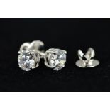 A PAIR OF SWAROVSKI CRYSTAL STUD EARRINGS, each designed as a circular Swarovski within a four